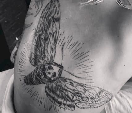Lady Gaga giant tattoo of a moth with a skull for a face.